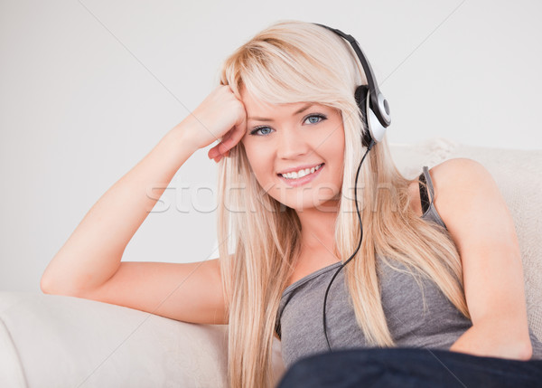 Vonzó fiatal szőke nő fejhallgató ül Stock fotó © wavebreak_media
