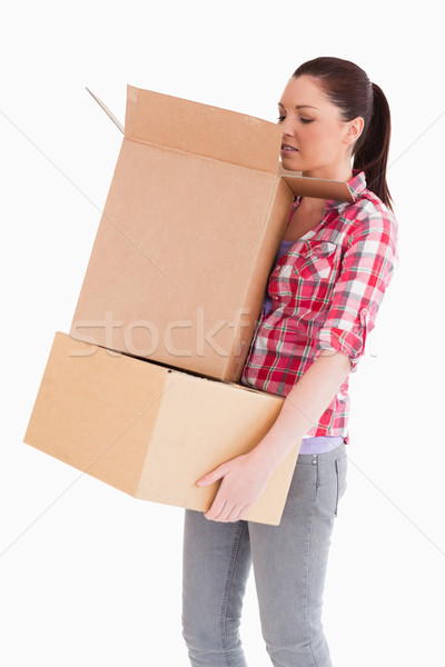 Beautiful woman looking inside a cardboard box while standing against a white background Stock photo © wavebreak_media