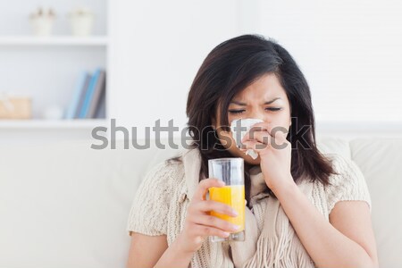 sad woman with orange juice in livingroom Stock photo © wavebreak_media