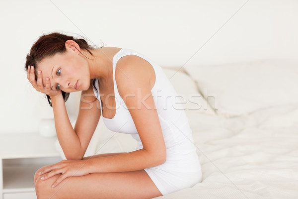 Sad woman sitting on her bed in her bedroom Stock photo © wavebreak_media