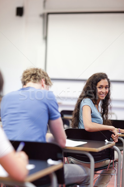 Portrait of a playful student sitting at a table in a classroom Stock photo © wavebreak_media