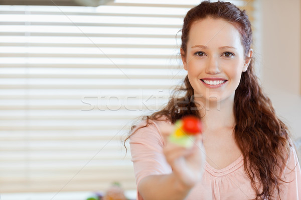 Smiling girl offering a mouthful of salad Stock photo © wavebreak_media