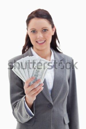 Close-up of a businesswoman smiling and holding a lot of dollar bank notes with focus on bank notes  Stock photo © wavebreak_media