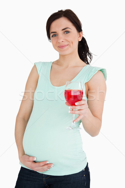 Pregnant woman holding a mocktail against white background Stock photo © wavebreak_media