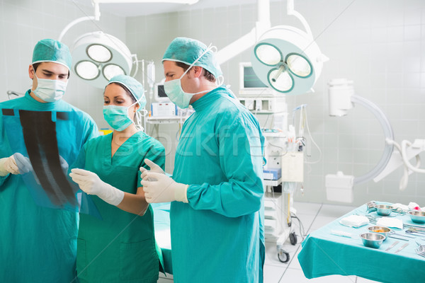 Medical team analysing a X-ray in an operating theatre Stock photo © wavebreak_media