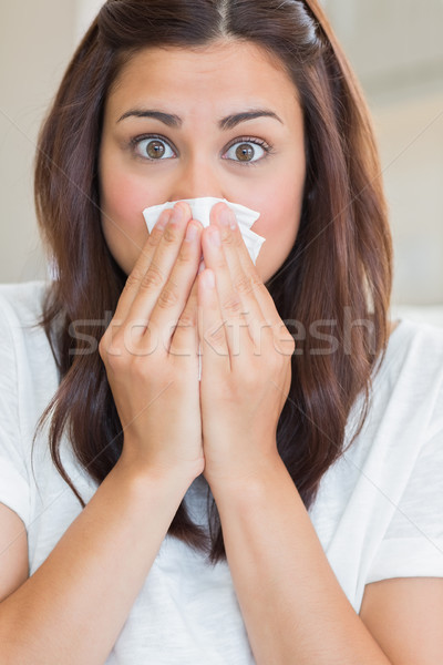 Brunette with runny nose at home Stock photo © wavebreak_media