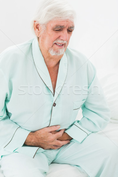 Uomo dolore stomaco anziani home camera da letto Foto d'archivio © wavebreak_media