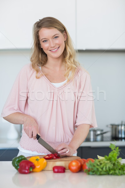 Young woman chopping vegetables at kitchen counter Stock photo © wavebreak_media
