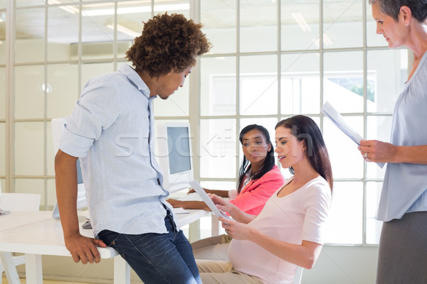 Pregnant casual businesswoman talking with colleagues Stock photo © wavebreak_media