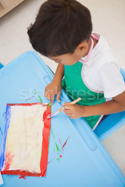 Cute little boy painting at table in classroom Stock photo © wavebreak_media