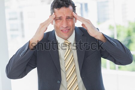 Businessman with severe headache at office Stock photo © wavebreak_media