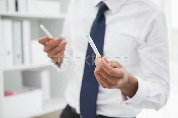 Mid section of a businessman holding cigarettes Stock photo © wavebreak_media