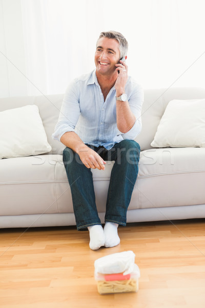 Happy man phoning on the couch Stock photo © wavebreak_media