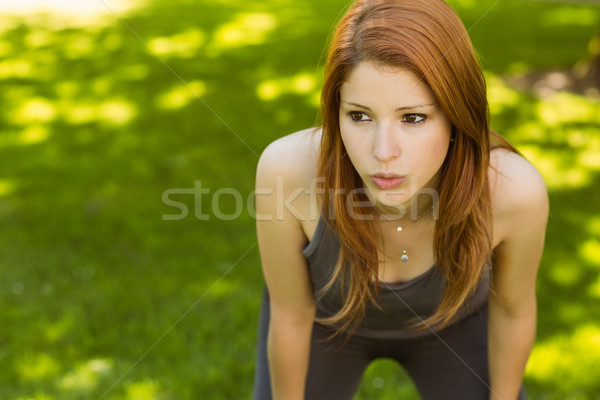 Pretty redhead panting in the park Stock photo © wavebreak_media