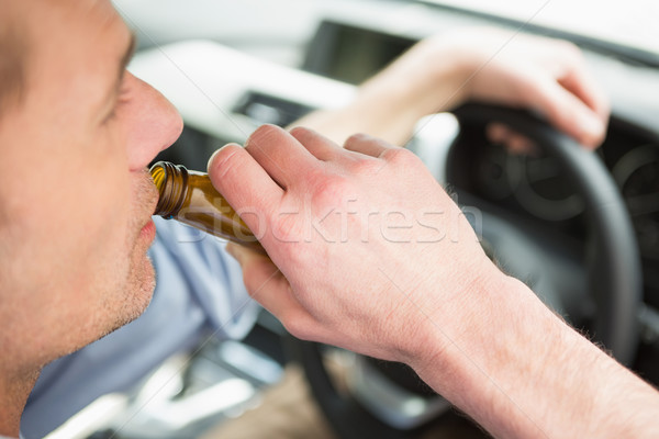 Man drinking beer while driving Stock photo © wavebreak_media
