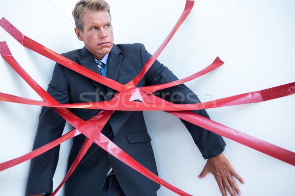 Businessman trapped by red tape Stock photo © wavebreak_media