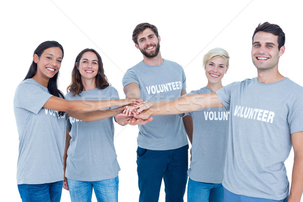 Wolontariusze znajomych ręce wraz szczęśliwy człowiek Zdjęcia stock © wavebreak_media