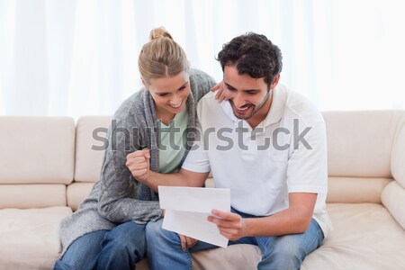 Worried couple calculating bills on the couch Stock photo © wavebreak_media