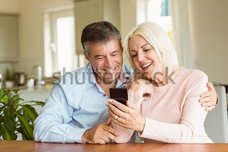 Smiling couple petting their gringer cat on the couch Stock photo © wavebreak_media