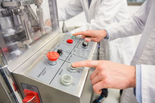Pharmacist pressing button on machine Stock photo © wavebreak_media