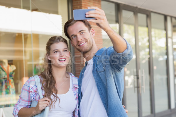 A smiling happy couple taking selfies Stock photo © wavebreak_media