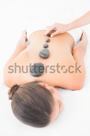 Pretty brunette enjoying a hot stone massage Stock photo © wavebreak_media