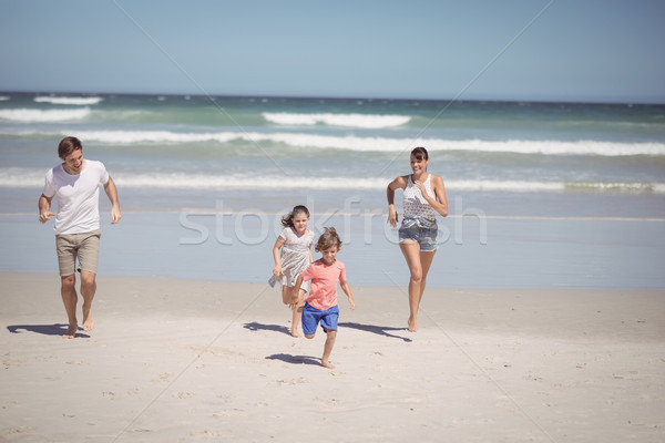 Happy family running at beach Stock photo © wavebreak_media