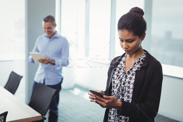 Executives using digital tablet and mobile phone Stock photo © wavebreak_media