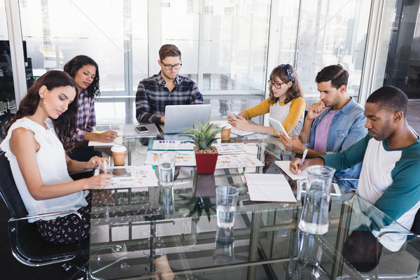 Focused creative business team working around glass table Stock photo © wavebreak_media