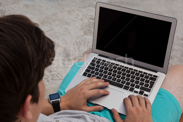 High angle view of man using laptop at beach Stock photo © wavebreak_media