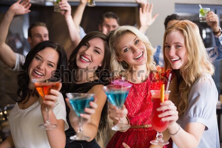 Female friends toasting disposable cups in club Stock photo © wavebreak_media