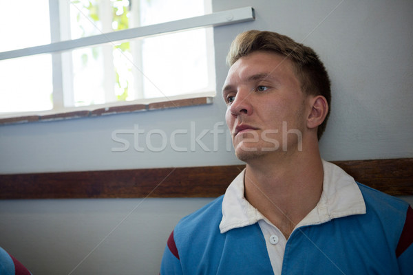 Close up of thoughtful rugby player sitting against wall Stock photo © wavebreak_media