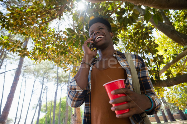 Stock photo: Man talking on mobile phone in the park