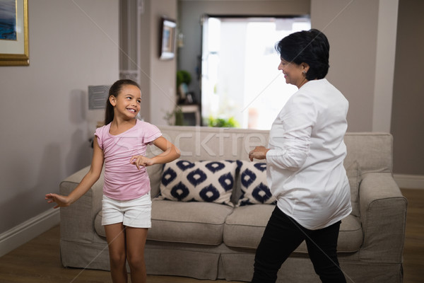 Smiling girl dancing with grandmother Stock photo © wavebreak_media