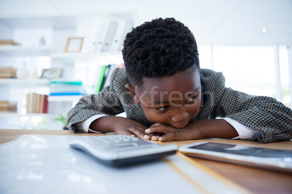 Bored businessman leaning on desk while looking away Stock photo © wavebreak_media