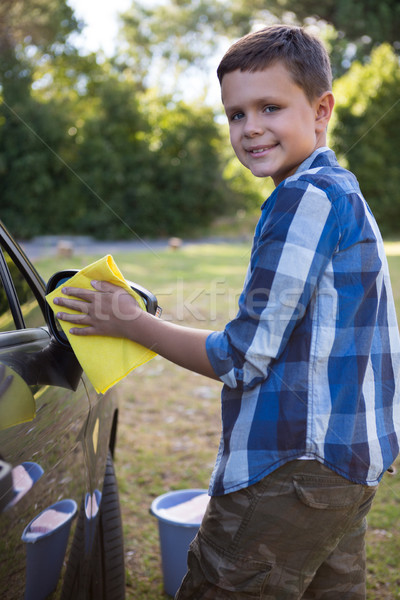 Teenage boy washing a car on a sunny day Stock photo © wavebreak_media