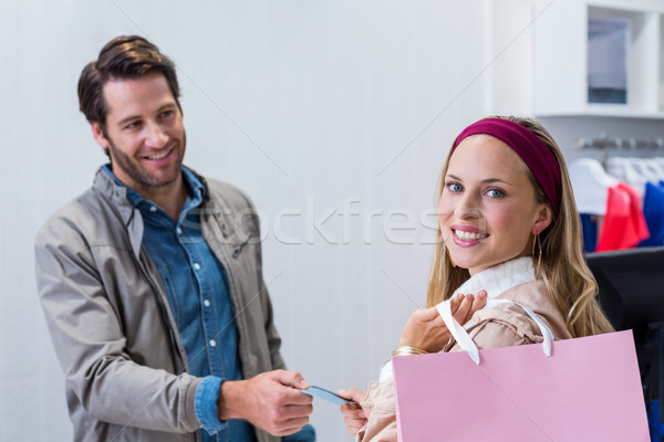 Smiling woman getting back credit card Stock photo © wavebreak_media