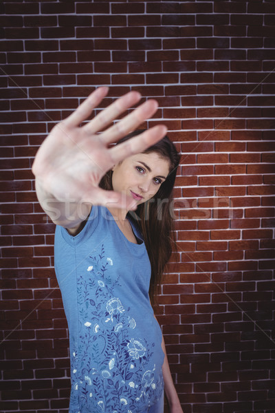 Pretty brunette with hand up Stock photo © wavebreak_media