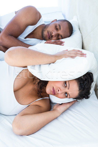 Disturbed wife sleeping besides snoring husband Stock photo © wavebreak_media