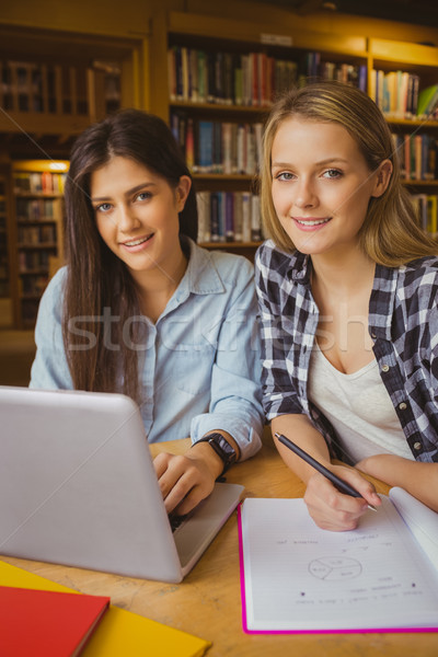 Foto stock: Sonriendo · estudiantes · usando · la · computadora · portátil · biblioteca · mujer · nina