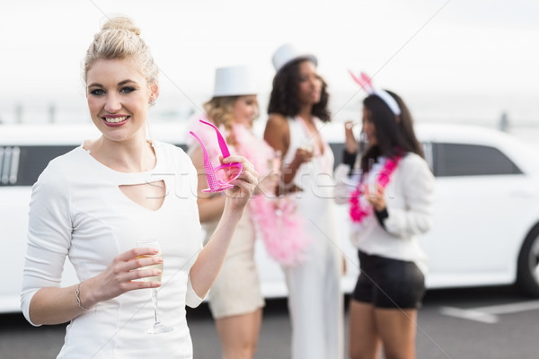 Frivolous women drinking champagne next to a limousine Stock photo © wavebreak_media