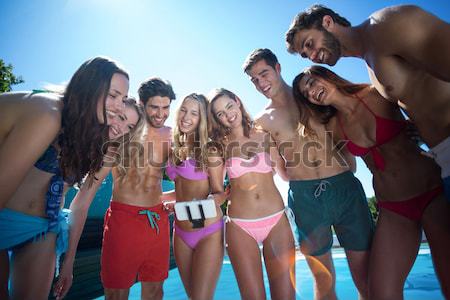 Happy friends in swimwear standing together Stock photo © wavebreak_media