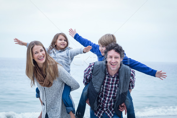 Happy parents carrying children at beach  Stock photo © wavebreak_media