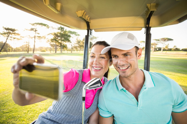 Fericit jucător de golf cuplu autoportret şedinţei Imagine de stoc © wavebreak_media