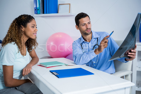 Stock photo: Physiotherapist explaining x-ray to patient