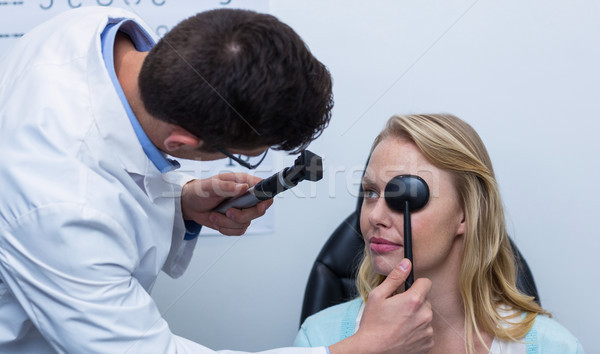 Optometrist examining female patient with medical equipment Stock photo © wavebreak_media