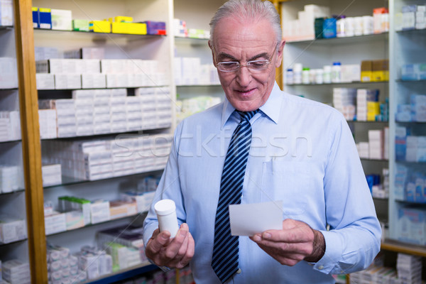 Pharmacist holding a prescription and medicine Stock photo © wavebreak_media