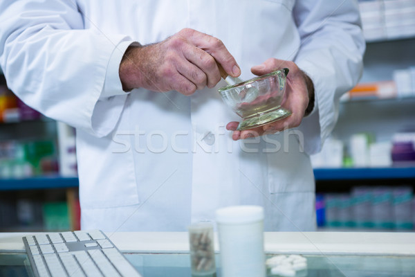 Pharmacist grinding medicine with mortar and pestle Stock photo © wavebreak_media