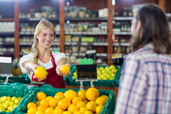 Smiling staff assisting a man with grocery shopping Stock photo © wavebreak_media