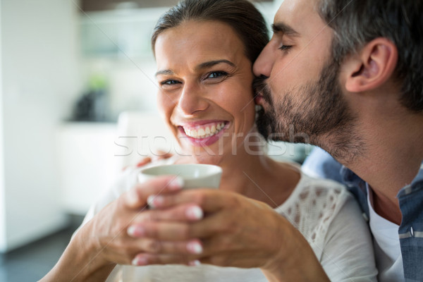 Om sărutat femeie obrajii cafea acasă Imagine de stoc © wavebreak_media